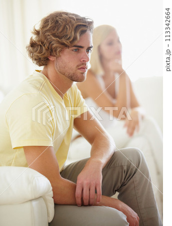 Angry couple, fight and divorce stress on a sofa with argument, anxiety or cheating depression in their home. Marriage crisis, dispute and overthinking man ignore frustrated woman in a living room 113342664