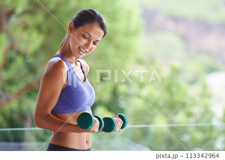Happy woman, fitness and weightlifting with dumbbells for exercise, workout or muscle gain on balcony. Female person with smile for lifting weight or small barbells for outdoor training on terrace 113342964