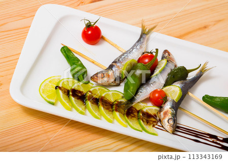 Broiled anchovies on skewers 113343169