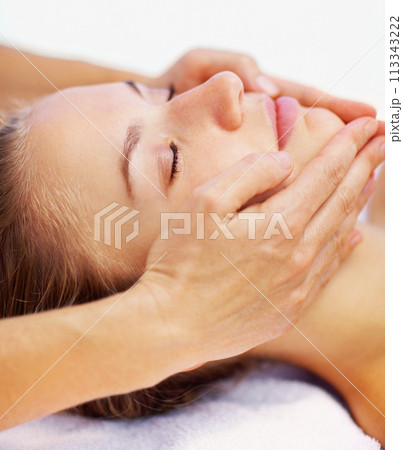 Woman, relax and face massage with spa therapist for wellness, holistic therapy and reiki in studio on white background. Beauty, skincare and or client rest for facial acupressure, treatment or peace 113343222