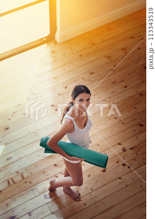 Woman, portrait and mat for yoga in home, wellness and above for spiritual awareness. Happy female person, pilates and exercise or fitness in living room, zen and mindfulness for morning routine 113343519