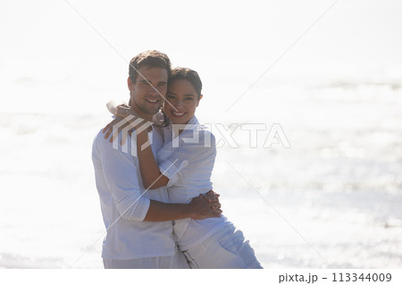 Travel, hug and portrait of couple on beach for bonding, relax together and relationship by ocean. Dating, happy and man and woman embrace for romance on holiday, vacation and weekend in nature 113344009