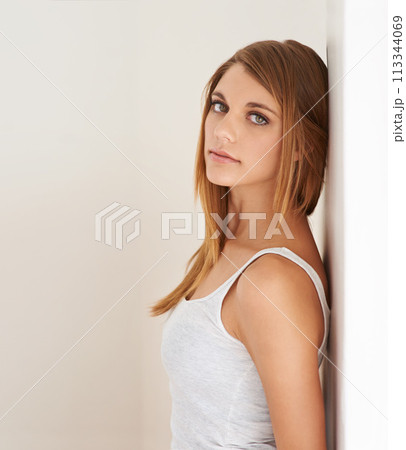 Beauty, portrait and woman leaning on wall with natural makeup in white background of studio. Serious, model and glow on skin from cosmetics and skincare aesthetic with calm, confidence and pride Beauty, portrait and woman leaning on wall with natural makeup in white background of studio. Serious, model and glow on skin from cosmetics and skincare aesthetic with calm, confidence and pride 113344069