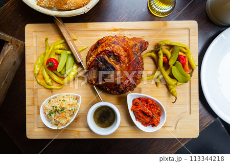 Roasted Ham Hock with pickled vegetables on wooden tray Roasted Ham Hock with pickled vegetables on wooden tray 113344218
