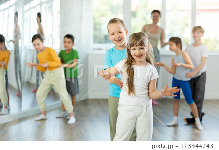 Girl paired up with boy and training to perform boogie woogie couple dance, rehearse performance. 113344243