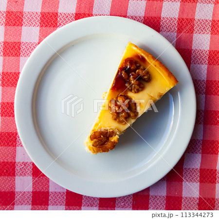 Cake with walnuts on white plate 113344273