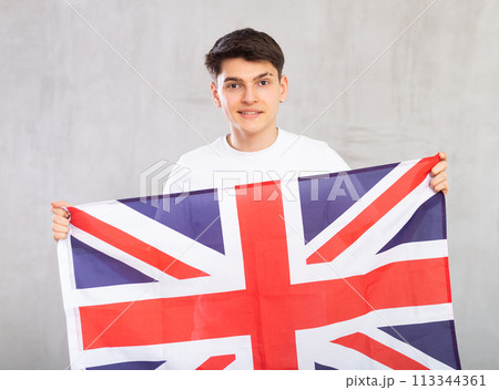 Male football fan holding Great Britain flag 113344361