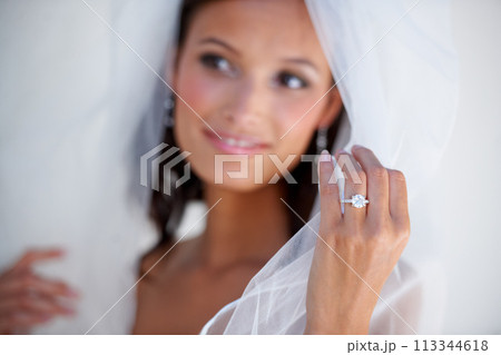 Diamond, wedding ring and hand of bride with jewellery and pride for commitment, celebration or marriage. Bridal, aesthetic and woman closeup with engagement jewelry, fashion and veil fabric 113344618