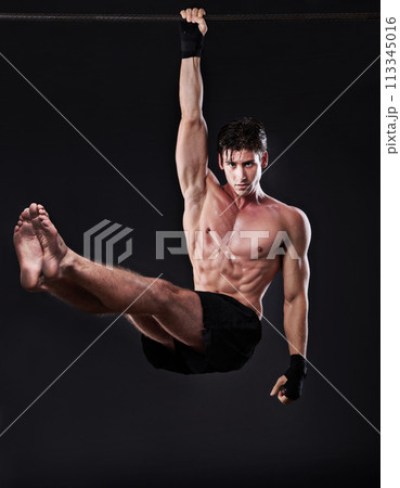 Man, fitness, and training bar in portrait for sport, workout and bodybuilding on black studio backdrop. Energy, pull up and muscle with male model for exercise hang and mma competition motivation 113345016