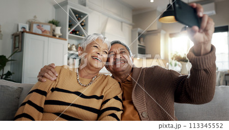 Senior couple, selfie and smile on sofa, hug and bonding with love, support and relax in retirement in home. Elderly woman, old man and happy with profile profile, web blog and social media on couch 113345552