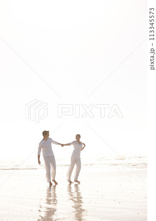 Couple, ocean and holding hands for walk on beach, travel and commitment with trust and bonding outdoor. Love, care and support in relationship, honeymoon or anniversary with fun or playful in nature Couple, ocean and holding hands for walk on beach, travel and commitment with trust and bonding outdoor. Love, care and support in relationship, honeymoon or anniversary with fun or playful in nature 113345573