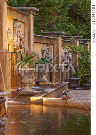 Pond, architecture and vintage in holiday resort for heritage, ancient and historic garden or structure in India. Travel, culture and vacation accommodation for tourist, adventure and leisure 113345581