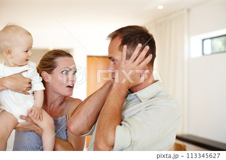 Couple, child and argument with home, family problem and frustration or anger for domestic life. Father, mother and kid in house, living room and problem with communication for parenting relationship 113345627