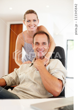 Smile, portrait and couple in hug on chair, love and proud of marriage milestone in home. Happy, embrace and people for relationship achievement, romance and bonding in apartment for enjoyment 113345642