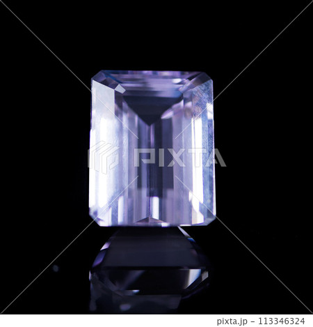 Purple, gemstone or jewelry on a black background for luxury, expensive and rich design in studio. Violet, diamond or crystal rock for texture, glamour and ring with shine and reflection for gift 113346324