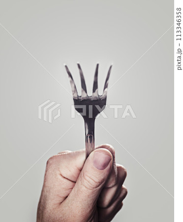 Bending, fork and hand with closeup, person and utensils with kitchen tool on a white studio background. Mockup space, promotion and model with superpower and magic with design, artistic and creative 113346358