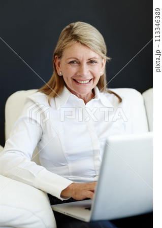 Mature businesswoman, portrait and laptop on couch, planning and internet for b2b online communication. Female person, CEO and proud of startup company, finance and happy accountant for ideas on web 113346389