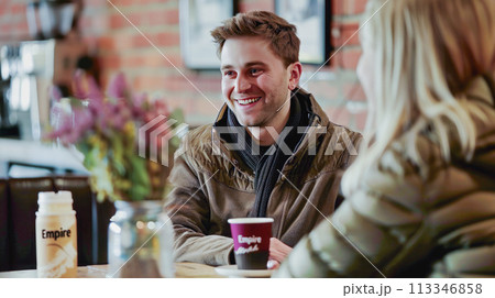 Talking and smiling with customers at a coffee shop. 113346858