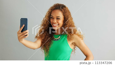 Happy woman, peace sign and selfie with kiss for social media, vlog or memory on a gray studio background. Female person with smile on mobile smartphone for photography or picture on mockup space Happy woman, peace sign and selfie with kiss for social media, vlog or memory on a gray studio background. Female person with smile on mobile smartphone for photography or picture on mockup space 113347206