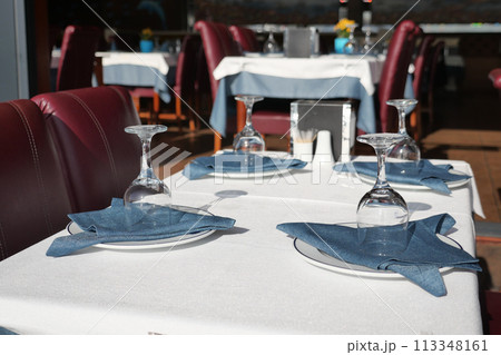 served and decorated round festive table in a restaurant served and decorated round festive table in a restaurant 113348161