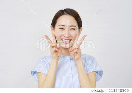 両手でピースサインをする女性　白背景 113348509