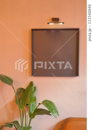 Black frame mockup in a living room hanging on a wall  113348848