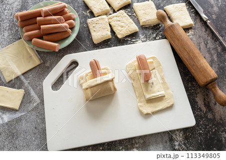 Cooking Easter rabbit-shaped buns puff pastry from sausage and cheese, step by step, step 2. 113349805