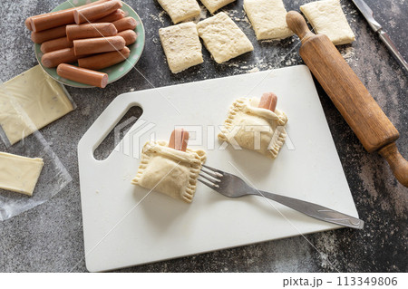 Cooking Easter rabbit-shaped buns puff pastry from sausage and cheese, step by step, step 4. 113349806