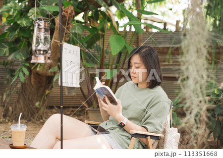 people activity with solo woman happy and relax during read book and outdoor camping 113351668