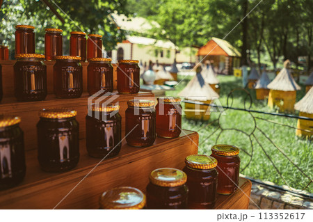 stack of jars with honey by apiary stack of jars with honey by apiary 113352617