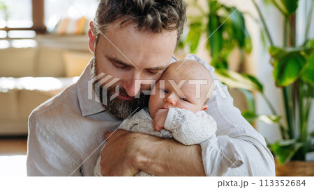 Father holding his newborn baby. Unconditional paternal love, Father's Day concept. 113352684
