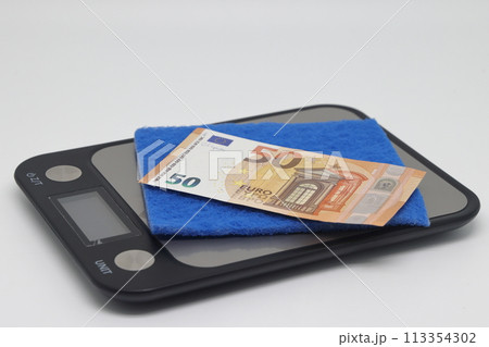 square multi colored new napkins for cleaning in the kitchen lie on electronic kitchen scales 113354302