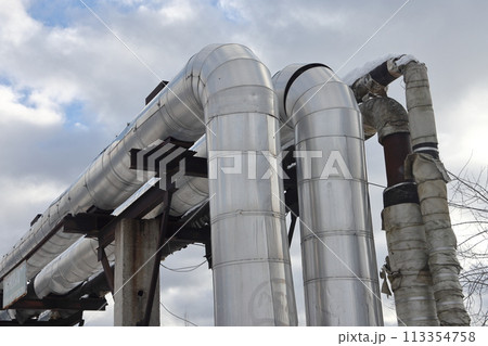 The main provides the city with hot water. Selective focus. The pipes of the central heating system The main provides the city with hot water. Selective focus. The pipes of the central heating system 113354758