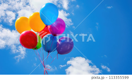 Colorful balloons with string tied together against a blue sky. Helium ballons floating in the air 113355599
