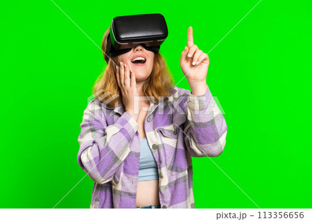 Excited woman in VR headset helmet watching virtual reality 3D video, playing simulation online game Excited woman in VR headset helmet watching virtual reality 3D video, playing simulation online game 113356656
