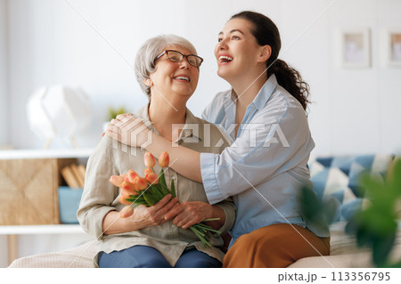 woman and her mother with flowers tulips 113356795