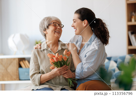 woman and her mother with flowers tulips woman and her mother with flowers tulips 113356796