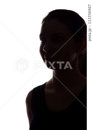 Young woman look ahead with flowing hair - isolated silhouette of a front view Young woman look ahead with flowing hair - isolated silhouette of a front view 113356987