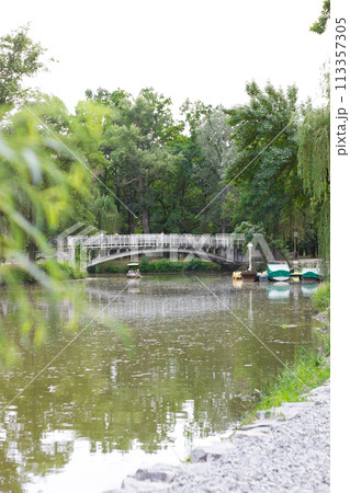 Beautiful bridge on the river - spring photo Beautiful bridge on the river - spring photo 113357305