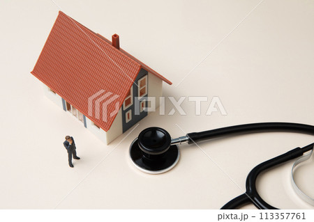 Miniature businessman and house with stethoscope Miniature businessman and house with stethoscope 113357761