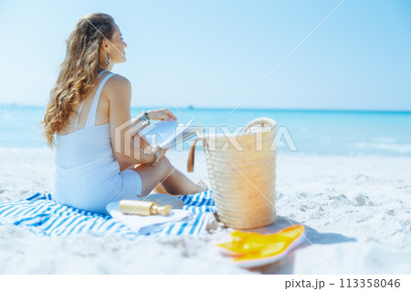 relaxed modern woman on seacoast with straw bag relaxed modern woman on seacoast with straw bag 113358046