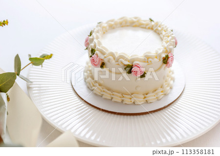 Festive bento cake and bouquet on a light background Festive bento cake and bouquet on a light background 113358181