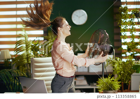 smiling modern business woman in modern green office smiling modern business woman in modern green office 113358865
