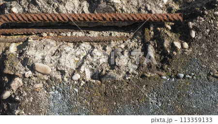 damaged reinforced concrete with exposed rebar 113359133