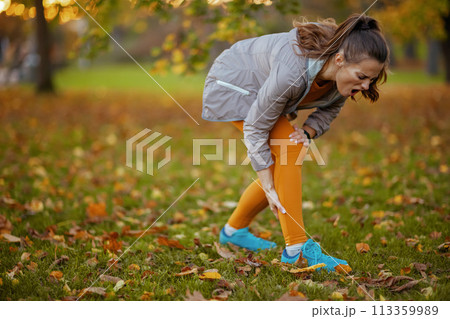 unhappy modern woman in fitness clothes in park unhappy modern woman in fitness clothes in park 113359989