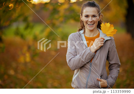 Portrait of happy elegant female in fitness clothes in park Portrait of happy elegant female in fitness clothes in park 113359990