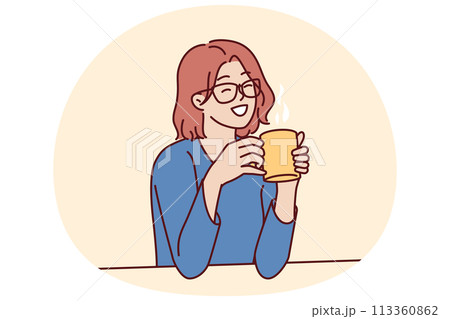Joyful woman holding coffee mug sitting at table and smiling remembering happy moments from life 113360862
