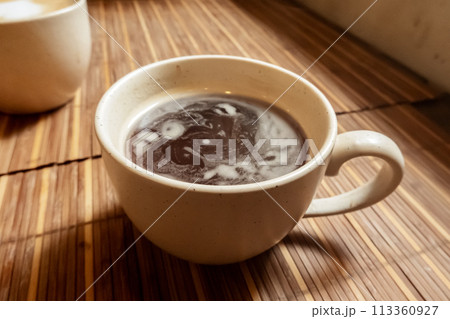 Americano coffee in a cafe, an atmospheric photo of a cup of black coffee 113360927