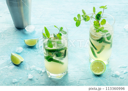 Mojito cocktail. Summer cold drink with lime, fresh mint, and ice. Cool beverage Mojito cocktail. Summer cold drink with lime, fresh mint, and ice. Cool beverage 113360996