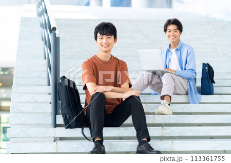 キャンパスライフを楽しむ大学生の男性 113361755